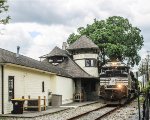 SU 99 rolls through downtown passing the former L&HR Rwy station 